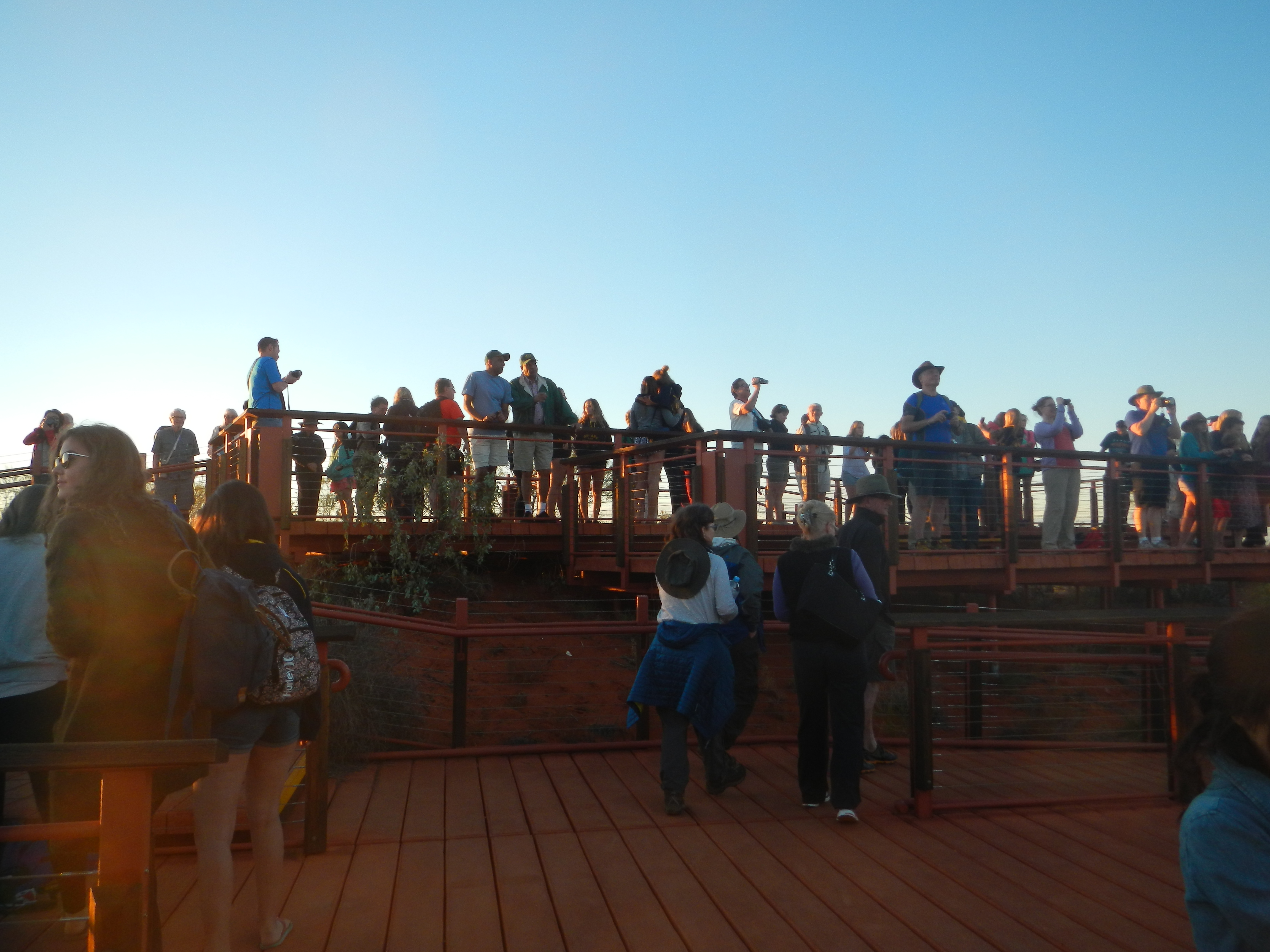 A crowd in from of Uluru before sunrise